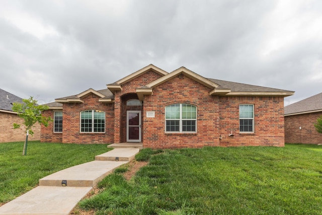 3508 Bismarck Ave, Amarillo, TX 79118 - view of front facade featuring brick siding, a front yard, and roof with shingles
