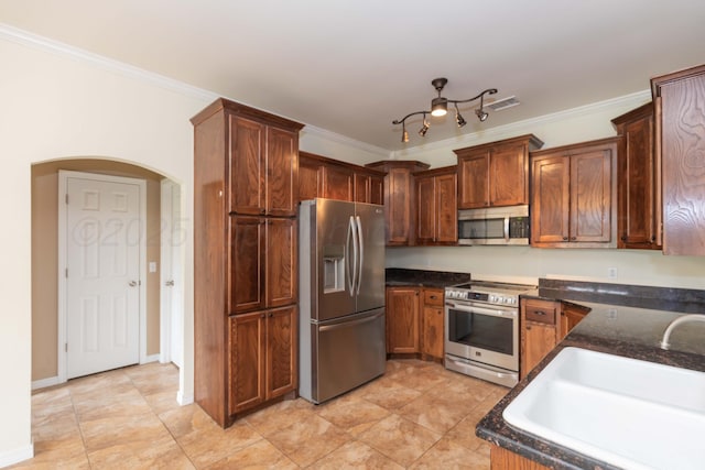 3508 Bismarck Ave, Amarillo, TX 79118 - kitchen with stainless steel appliances, a sink, arched walkways, crown molding, and dark stone countertops