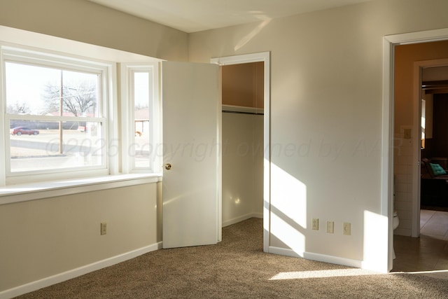 unfurnished bedroom with a closet and carpet