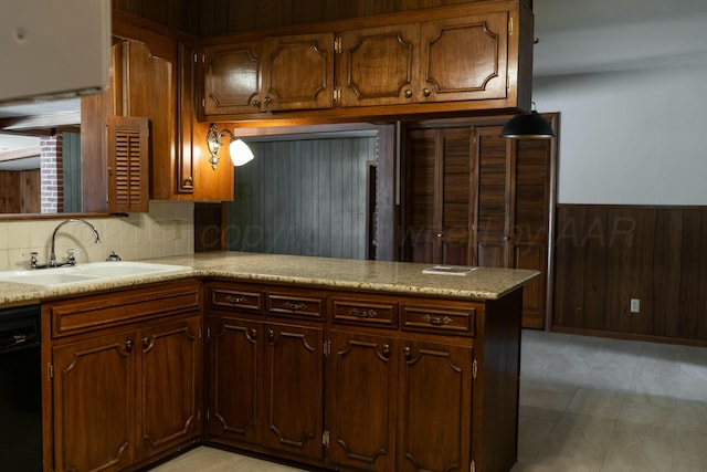 kitchen with sink, wood walls, black dishwasher, kitchen peninsula, and decorative backsplash