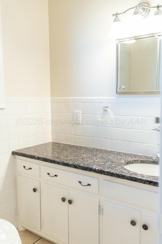 bathroom with tile walls and vanity