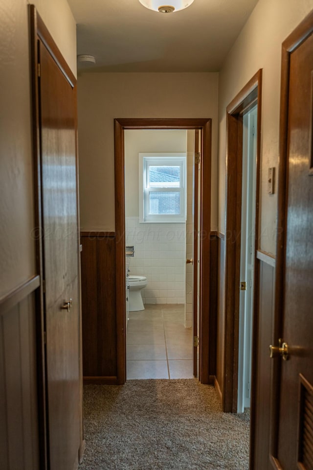 hallway featuring light colored carpet