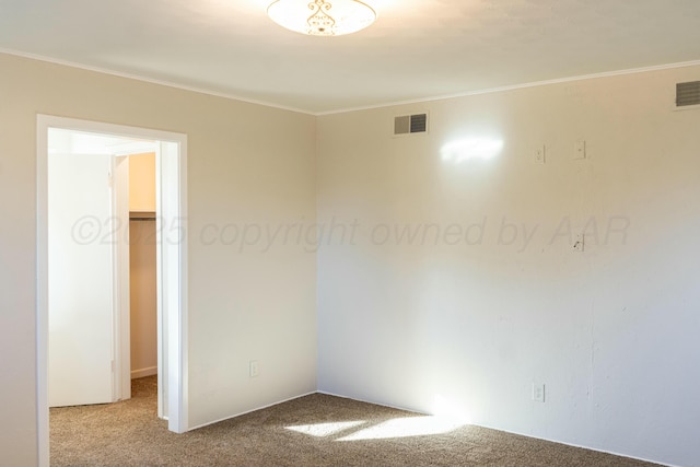 carpeted spare room with ornamental molding