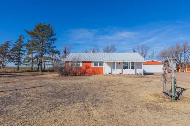 ranch-style house featuring metal roof