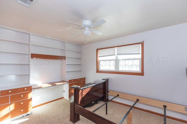 carpeted home office featuring ceiling fan, visible vents, and baseboards