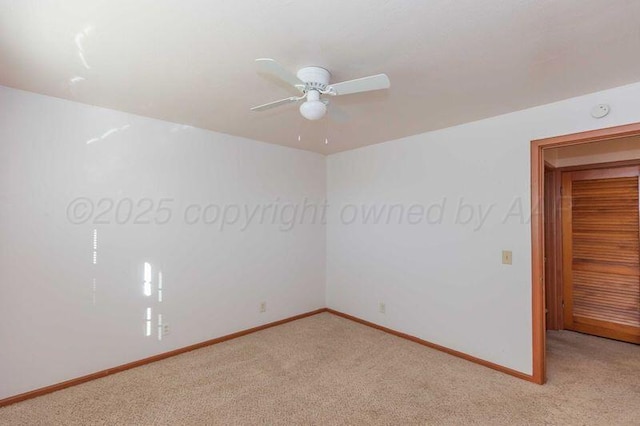 unfurnished room with ceiling fan, baseboards, and light colored carpet