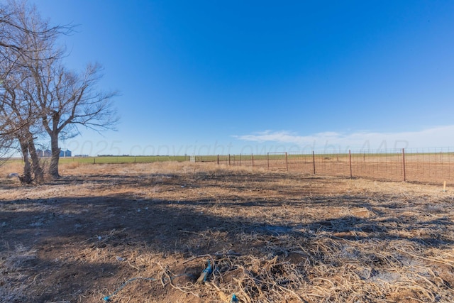 view of yard with a rural view and fence