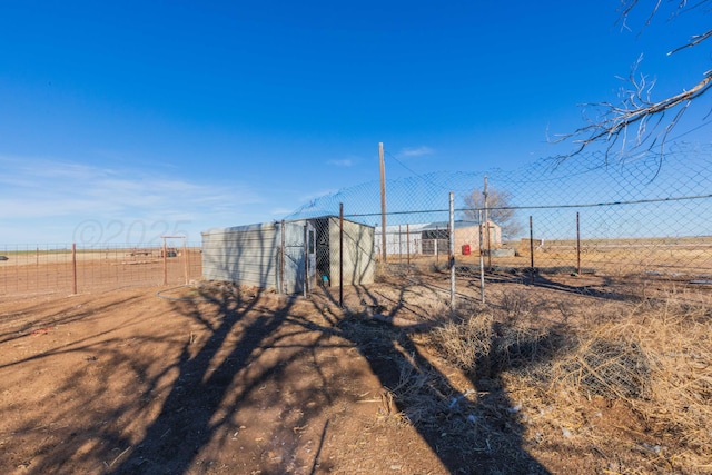 view of yard featuring an outbuilding and fence