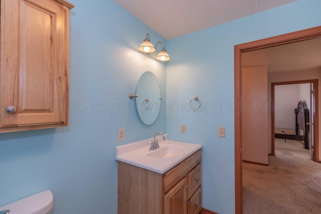 bathroom with toilet and vanity