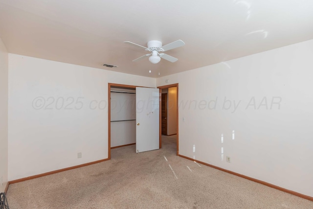 unfurnished bedroom with baseboards, visible vents, a closet, and light colored carpet