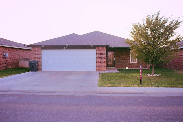 view of front of home featuring a garage and a front yard