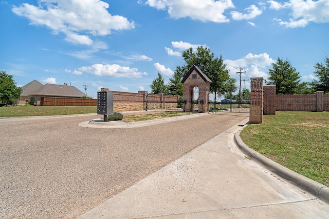 4 Kingsridge Pl, Amarillo, TX 79106 - view of asphalt road with curbs, a gate, and a gated entry