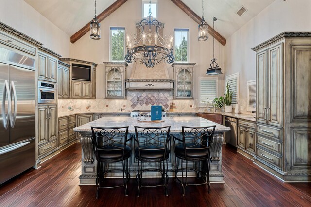 4 Kingsridge Pl, Amarillo, TX 79106 - kitchen with appliances with stainless steel finishes, high vaulted ceiling, glass insert cabinets, a kitchen island, and dark wood finished floors
