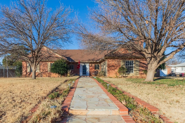 ranch-style home featuring a front yard