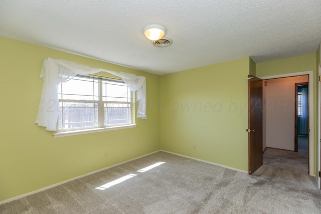 6111 Princeton St, Amarillo, TX 79109 - carpeted empty room featuring a textured ceiling and baseboards