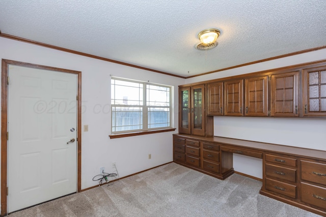 6111 Princeton St, Amarillo, TX 79109 - unfurnished office with a textured ceiling, light colored carpet, ornamental molding, and built in desk