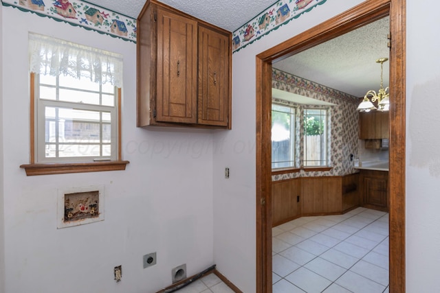 6111 Princeton St, Amarillo, TX 79109 - laundry room featuring electric dryer hookup, a textured ceiling, a chandelier, hookup for a washing machine, and healthy amount of natural light