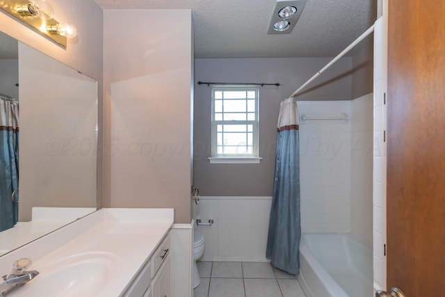 6111 Princeton St, Amarillo, TX 79109 - full bath featuring a textured ceiling, tile patterned flooring, vanity, a wainscoted wall, and shower / bath combination with curtain