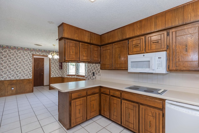 6111 Princeton St, Amarillo, TX 79109 - kitchen with white appliances, wallpapered walls, light countertops, a textured ceiling, and a peninsula