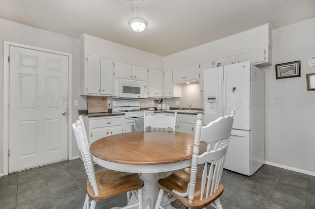 5222 S Travis St, Amarillo, TX 79110 - dining room with a textured ceiling and dark tile patterned floors