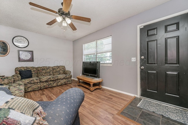 5222 S Travis St, Amarillo, TX 79110 - living area featuring wood finished floors, ceiling fan, and a textured ceiling