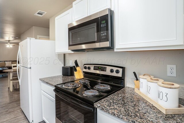 5012 Locker St, Amarillo, TX 79118 - kitchen with stainless steel microwave, electric stove, white cabinets, and dark stone countertops