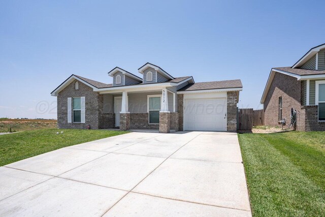 5012 Locker St, Amarillo, TX 79118 - view of front of house with a garage, concrete driveway, covered porch, and brick siding