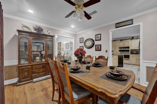 5105 Black Oak Dr, Amarillo, TX 79110 - dining room with a ceiling fan, light wood-style floors, crown molding, and a textured ceiling