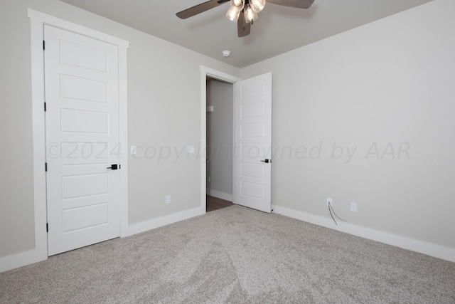 unfurnished bedroom featuring carpet flooring, a ceiling fan, and baseboards