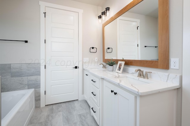 bathroom with a sink, a washtub, and double vanity