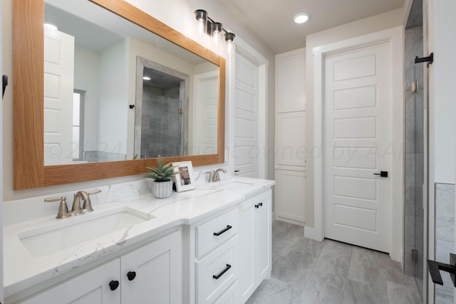 bathroom featuring double vanity, a sink, recessed lighting, and tiled shower
