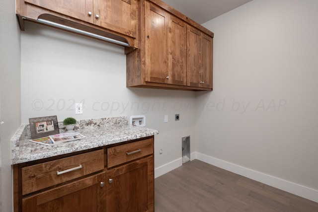 laundry area featuring dark wood-style flooring, baseboards, hookup for a washing machine, cabinet space, and hookup for an electric dryer