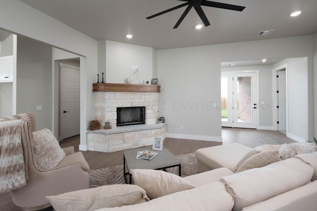 living area featuring ceiling fan, visible vents, a fireplace, wood finished floors, and recessed lighting