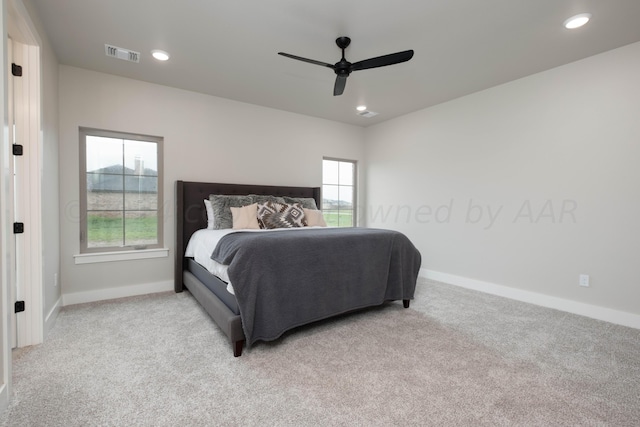 bedroom featuring light colored carpet, baseboards, visible vents, and recessed lighting