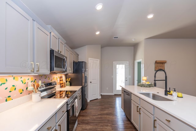 7701 Bellamy Dr, Amarillo, TX 79119 - kitchen featuring stainless steel appliances, light countertops, dark wood-type flooring, recessed lighting, and vaulted ceiling