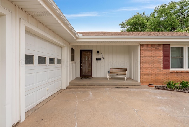 3607 Fleetwood Dr, Amarillo, TX 79109 - doorway to property with brick siding, a shingled roof, covered porch, a garage, and board and batten siding