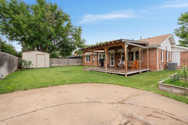 3607 Fleetwood Dr, Amarillo, TX 79109 - rear view of property featuring brick siding, a deck, a fenced backyard, and a storage unit