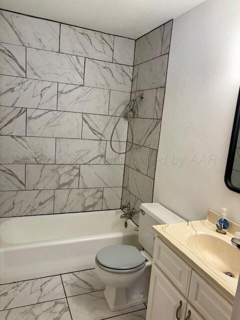 full bathroom featuring marble finish floor, tub / shower combination, vanity, and toilet