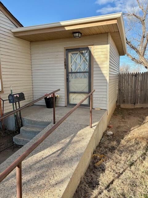 entrance to property featuring fence