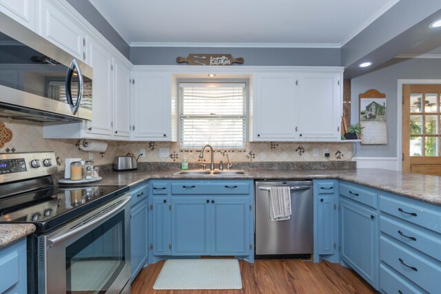 407 Thompson Ln, Canyon, TX 79015 - kitchen featuring white cabinetry, blue cabinets, appliances with stainless steel finishes, and a sink
