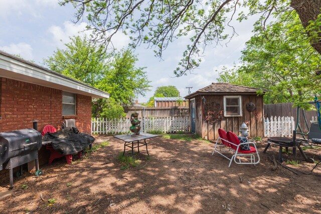 407 Thompson Ln, Canyon, TX 79015 - view of patio / terrace featuring an outbuilding, area for grilling, a storage shed, and a fenced backyard