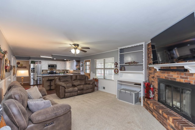 407 Thompson Ln, Canyon, TX 79015 - living area featuring a fireplace, ceiling fan, light carpet, and crown molding