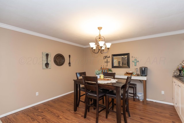 407 Thompson Ln, Canyon, TX 79015 - dining room with baseboards, dark wood-style flooring, a notable chandelier, and crown molding
