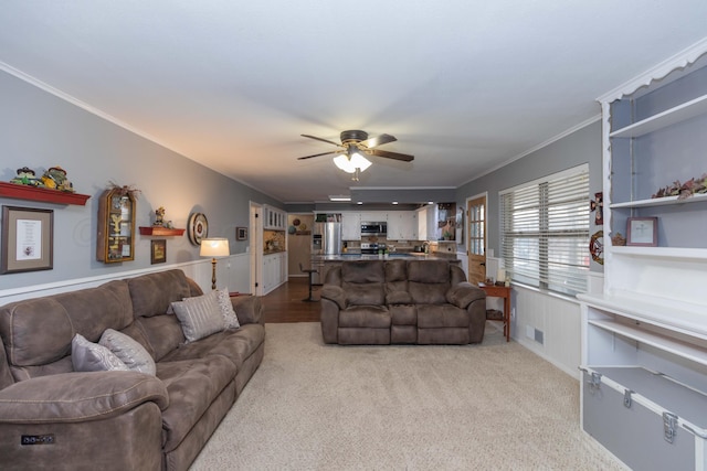 407 Thompson Ln, Canyon, TX 79015 - living area with carpet floors, visible vents, wainscoting, ceiling fan, and ornamental molding