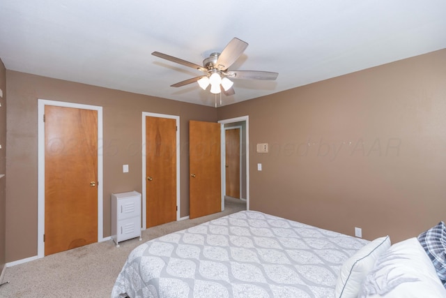 407 Thompson Ln, Canyon, TX 79015 - carpeted bedroom with baseboards, multiple closets, and ceiling fan