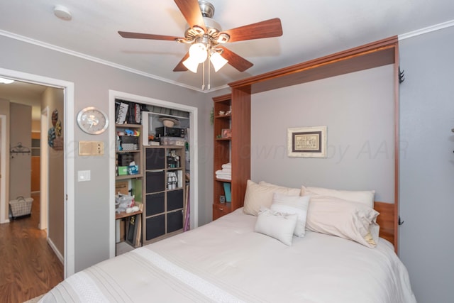 407 Thompson Ln, Canyon, TX 79015 - bedroom featuring ceiling fan, ornamental molding, a closet, and wood finished floors