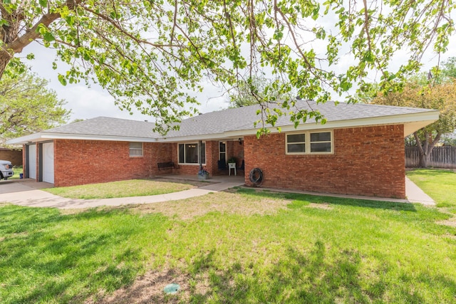 407 Thompson Ln, Canyon, TX 79015 - rear view of property with a lawn, brick siding, fence, and a garage