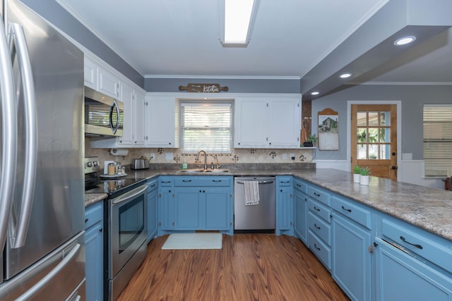 407 Thompson Ln, Canyon, TX 79015 - kitchen with white cabinetry, stainless steel appliances, blue cabinets, and a sink