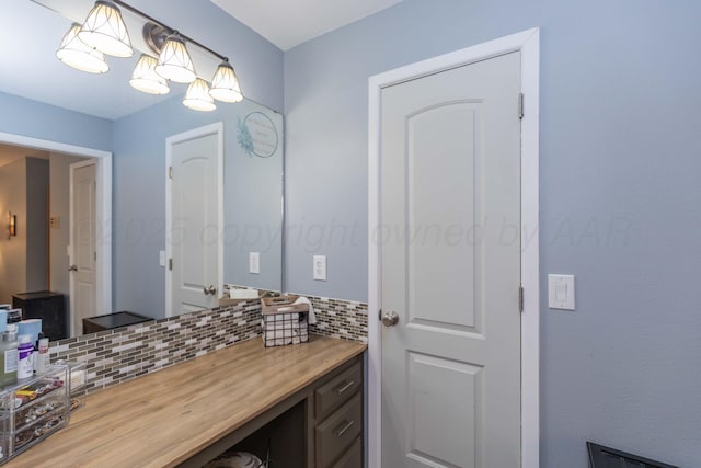 407 Thompson Ln, Canyon, TX 79015 - bathroom featuring vanity and decorative backsplash