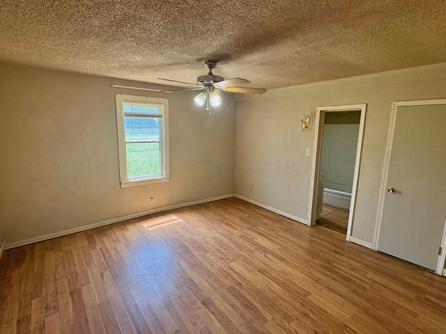 605 E 4th St, Panhandle, TX 79068 - unfurnished room featuring wood finished floors, a textured ceiling, ceiling fan, and baseboards